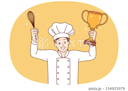 Man chef cook celebrates victory in professional culinary tournament, holds golden cup and whisk Man chef cook celebrates victory in professional culinary tournament, holds golden cup and whisk 134925079