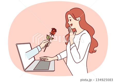 Gift flower from internet fan in laptop screen near enthusiastic woman using dating site 134925083