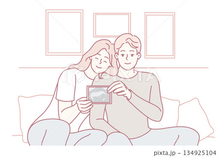 Smiling couple showing baby ultrasound Smiling couple showing baby ultrasound 134925104