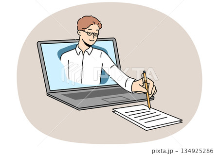 Business man takes notes on paper, looking out of laptop screen during online lecture for students 134925286