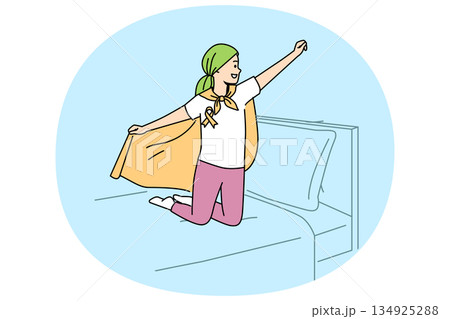 Child with oncology disease stands on bed in superhero pose, for concept day against cancer Child with oncology disease stands on bed in superhero pose, for concept day against cancer 134925288
