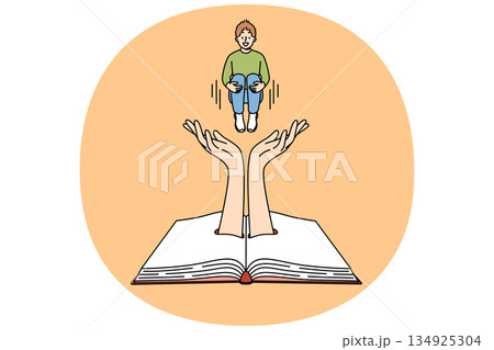 Little boy jumps above book, diving into plot of fantastic literature with exciting adventure story 134925304
