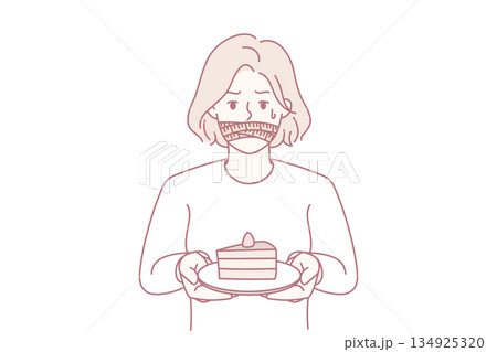 Smiling woman enjoys cake, Asian woman with slice of cake enjoying peaceful celebration mood 134925320