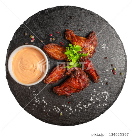 Fried chicken wings with dipping sauce on black slate board isolated on white background 134925597