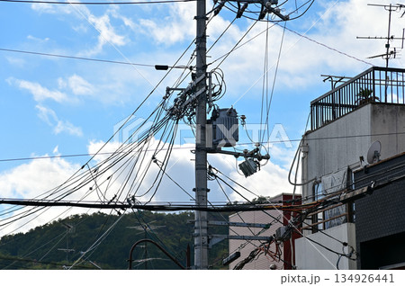 The view of utility pole, electric wires, electricity pylon at street in Kyoto, Japan. The view of utility pole, electric wires, electricity pylon at street in Kyoto, Japan. 134926441