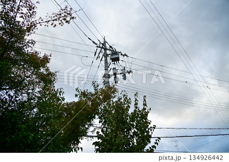 The view of utility pole, electric wires, electricity pylon at street in Kyoto, Japan. The view of utility pole, electric wires, electricity pylon at street in Kyoto, Japan. 134926442