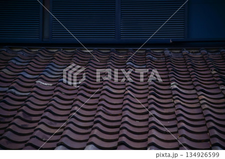 The rooftop of Japanese house, traditional Japanese house rooftop. Tile roof in Japan. Building exterior. Travel concept. The rooftop of Japanese house, traditional Japanese house rooftop. Tile roof in Japan. Building exterior. Travel concept. 134926599