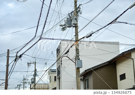 The view of utility pole, electric wires, electricity pylon at street in Kyoto, Japan. The view of utility pole, electric wires, electricity pylon at street in Kyoto, Japan. 134926875