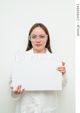 Portrait of Asian female research scientist against white background showing copy space Portrait of Asian female research scientist against white background showing copy space 134926941