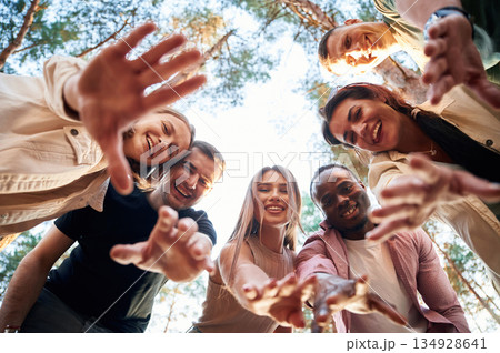 Looking down. View from below of group of friends that are in the forest 134928641