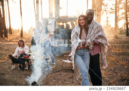 Conception of love, couple embracing each other. Group of friends are together in the forest Conception of love, couple embracing each other. Group of friends are together in the forest 134928667