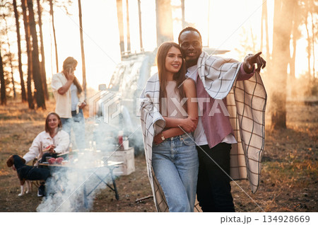 Hugs, embracing each other, multiracial couple. Group of friends are together in the forest Hugs, embracing each other, multiracial couple. Group of friends are together in the forest 134928669