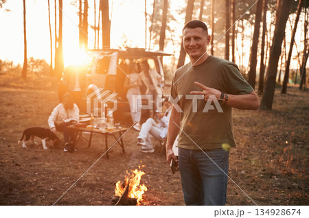 Happy man is smiling. Group of friends are together in the forest 134928674
