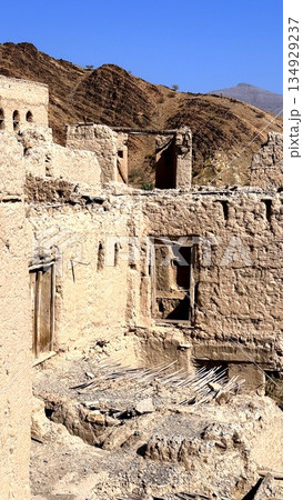 Cliffside Village With Ancient Dwellings, Archaeologist Surveys Historic Adobe Village On Elevated Cliffside, Panoramic Scene Of Ancient Adobe Homes Built On Steep Hillside With Erosion Features Cliffside Village With Ancient Dwellings, Archaeologist Surveys Historic Adobe Village On Elevated Cliffside, Panoramic Scene Of Ancient Adobe Homes Built On Steep Hillside With Erosion Features 134929237