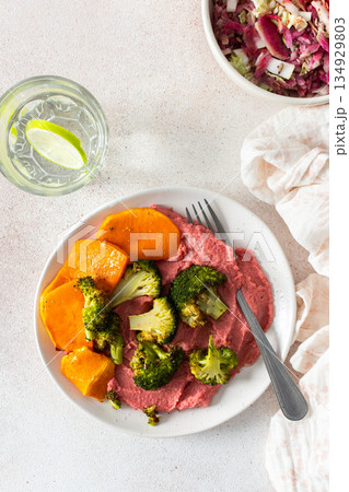 A wholesome breakfast with beet hummus, baked sweet potato, and a fresh radish and cabbage salad, rich in vitamins, fiber, and protein A wholesome breakfast with beet hummus, baked sweet potato, and a fresh radish and cabbage salad, rich in vitamins, fiber, and protein 134929803