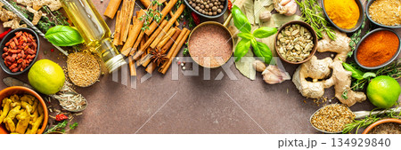 A visually striking arrangement of fresh spices and herbs on a brown surface, highlighting their vivid colors, intricate details, and rich culinary essence, banner A visually striking arrangement of fresh spices and herbs on a brown surface, highlighting their vivid colors, intricate details, and rich culinary essence, banner 134929840