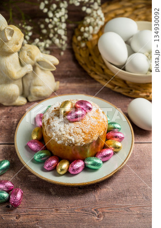 Easter spring holiday background. Cake with chocolate easter eggs, gypsophila flowers and bunny Easter spring holiday background. Cake with chocolate easter eggs, gypsophila flowers and bunny 134930092