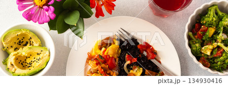 A nutritious and delicious breakfast plate featuring black rice with stewed vegetables, fresh tomato-broccoli-radish salad, avocado A nutritious and delicious breakfast plate featuring black rice with stewed vegetables, fresh tomato-broccoli-radish salad, avocado 134930416