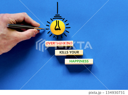 Overthinking kills your happiness symbol. Concept words Overthinking kills your happiness on wooden blocks. Beautiful blue background. Business overthinking kills happiness concept. Copy space. Overthinking kills your happiness symbol. Concept words Overthinking kills your happiness on wooden blocks. Beautiful blue background. Business overthinking kills happiness concept. Copy space. 134930731