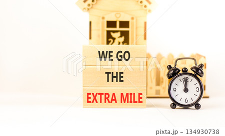 Support, help we go the extra mile symbol. Concept words We go the extra mile on beautiful wooden blocks. Beautiful white background. Black alarm clock. Business we go extra mile concept. Copy space. Support, help we go the extra mile symbol. Concept words We go the extra mile on beautiful wooden blocks. Beautiful white background. Black alarm clock. Business we go extra mile concept. Copy space. 134930738