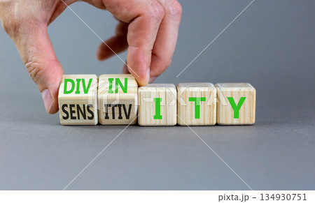 Sensitivity or divinity symbol. Concept words Sensitivity or Divinity on wooden cubes. Beautiful grey background. Psychologist hand. Psychology sensitivity or divinity concept. Copy space. 134930751