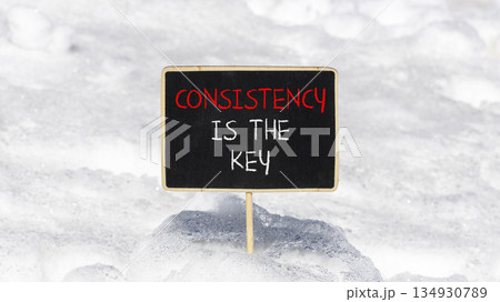 Consistency is the key symbol. Concept words Consistency is the key on beautiful blackboard. Beautiful white snow background. Business consistency is the key concept. Copy space. Consistency is the key symbol. Concept words Consistency is the key on beautiful blackboard. Beautiful white snow background. Business consistency is the key concept. Copy space. 134930789