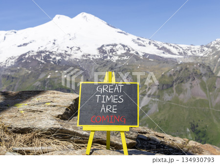Great times are coming symbol. Concept words Great times are coming on beautiful black blackboard. Beautiful mountain Elbrus background. Business great times are coming concept. Copy space. 134930793