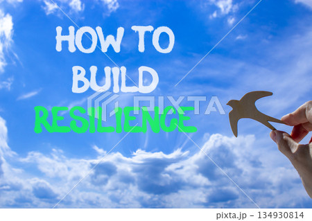 How to build resilience symbol. Concept words How to build resilience on beautiful blue sky. Beautiful blue sky background. Businessman's hand. Business how to build resilience concept. Copy space. How to build resilience symbol. Concept words How to build resilience on beautiful blue sky. Beautiful blue sky background. Businessman's hand. Business how to build resilience concept. Copy space. 134930814