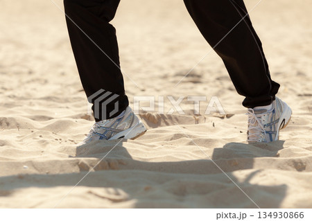 Jogging walking. Female legs hiking on the beach. Jogging walking. Female legs hiking on the beach. 134930866