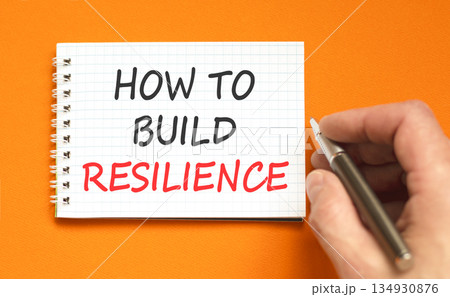 How to build resilience symbol. Concept words How to build resilience on beautiful white note. Beautiful orange background. Businessman's hand. Business how to build resilience concept. Copy space. How to build resilience symbol. Concept words How to build resilience on beautiful white note. Beautiful orange background. Businessman's hand. Business how to build resilience concept. Copy space. 134930876