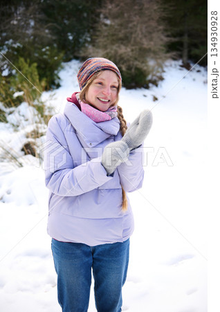 Happy Winter Moment: Girl In Purple Jacket Clapping Hands In Snowy Park 134930928