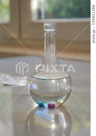 Glass Flask with Liquid and Crystals Vertical 134931366