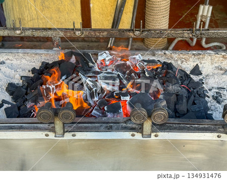 Burning Charcoal in Grill Firebox 134931476