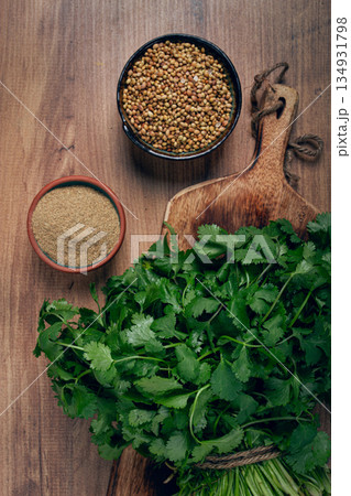 a bunch of fresh cilantro, coriander seeds and powder bowls, close-up, top view, no people, food and drinks, 134931798