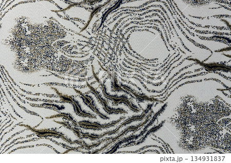 Light gray-beige jacquard fabric texture with metallic lurex and dark graphite abstract pattern, textile collection 134931837