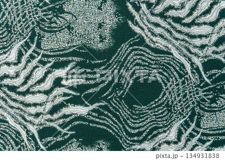 Dark teal jacquard fabric texture with metallic lurex and abstract wave pattern, part of textile collection 134931838