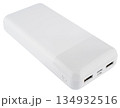 White compact power bank with two USB ports and a charge level indicator. On a white background 134932516