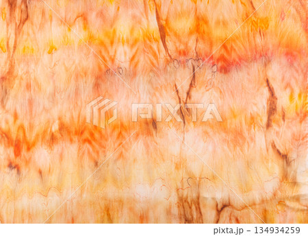 abstract pattern on silk fabric texture in yellow and brown tones abstract pattern on silk fabric texture in yellow and brown tones 134934259