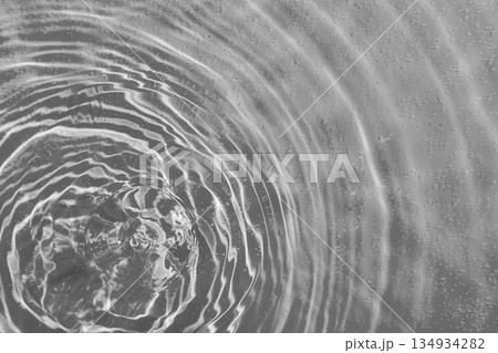 drops on water with circles on a grey background drops on water with circles on a grey background 134934282