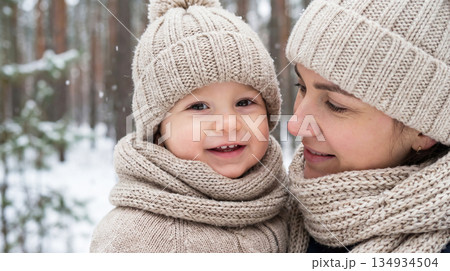 The tenderness of a child in mother's arms in the winter 134934504