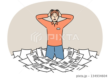 Paperwork and bureaucracy frighten man standing among pile of paper documents and clutching head Paperwork and bureaucracy frighten man standing among pile of paper documents and clutching head 134934604