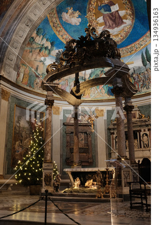 Basilica of the Holy Cross in Jerusalem Rome apse with mosaic baldachin and nativity scene Christmas decorations ornate Catholic church interior editorial use only. High quality photo 134936163