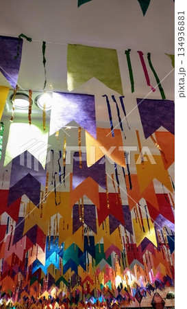 Light illuminating Junh Saint flags in purple, orange, green, red and blue. 134936881