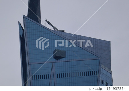 Contemporary skyscraper in Kuala Lumpur, Malaysia, featuring sharp glass geometry and modern urban architecture against a calm evening sky. Contemporary skyscraper in Kuala Lumpur, Malaysia, featuring sharp glass geometry and modern urban architecture against a calm evening sky. 134937254