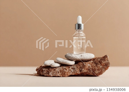 Glass dropper bottle with extract coconut or serum on stand from natural stones on beige background. Natural Organic Spa Cosmetic concept, cosmetic product mock up, minimal style. Side view, copyspace 134938006