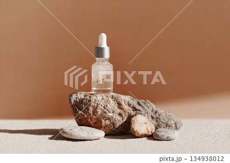 Glass dropper bottle with extract coconut or serum on stand from natural stones on beige background. Natural Organic Spa Cosmetic concept, cosmetic product mock up, minimal style. Side view, copyspace Glass dropper bottle with extract coconut or serum on stand from natural stones on beige background. Natural Organic Spa Cosmetic concept, cosmetic product mock up, minimal style. Side view, copyspace 134938012