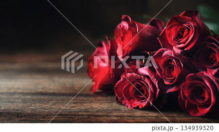 red rose bouquet on dark wooden table background 134939320