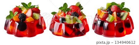 Bright red jelly salad dessert topped with fresh berries, mint leaves, marshmallows and candy isolated on white background Bright red jelly salad dessert topped with fresh berries, mint leaves, marshmallows and candy isolated on white background 134940612