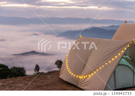 Camping tents in the mountains, and morning mist. Camping tents in the mountains, and morning mist. 134943733