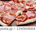 Sliced ham pizza with melted cheese and tomato sauce. 134944664